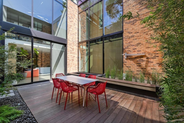 wooden terrace with outdoor dining area