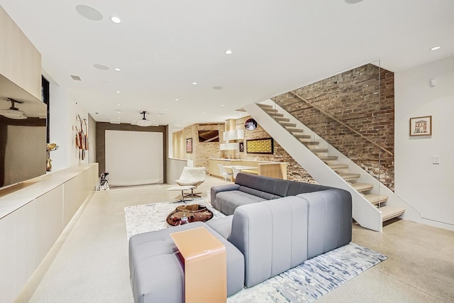 living room with visible vents, brick wall, stairway, concrete flooring, and recessed lighting