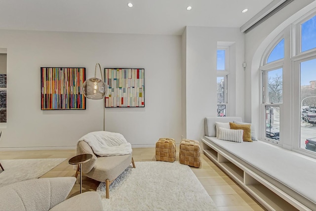 living area with recessed lighting, baseboards, and light wood-style floors