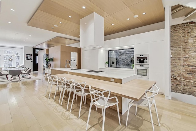 dining space with recessed lighting, light wood-style flooring, brick wall, and wood ceiling