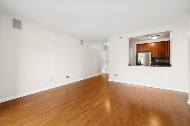 unfurnished living room featuring hardwood / wood-style flooring