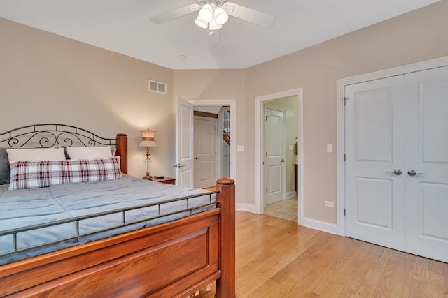 bedroom with ceiling fan, light hardwood / wood-style floors, and a closet