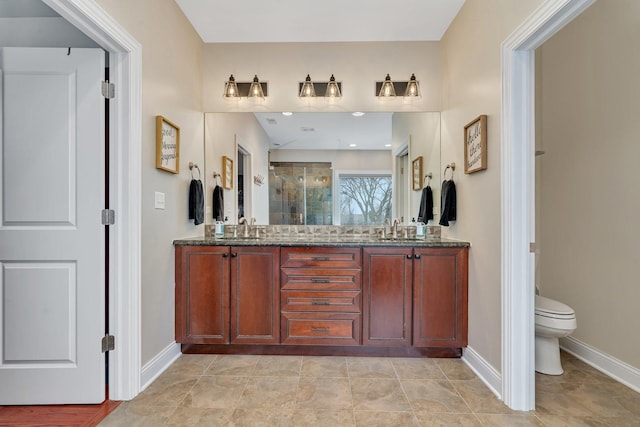 bathroom with vanity, an enclosed shower, and toilet