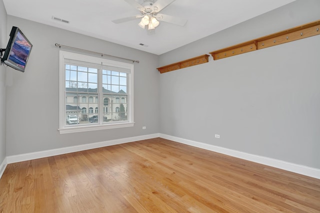 unfurnished room with hardwood / wood-style flooring and ceiling fan