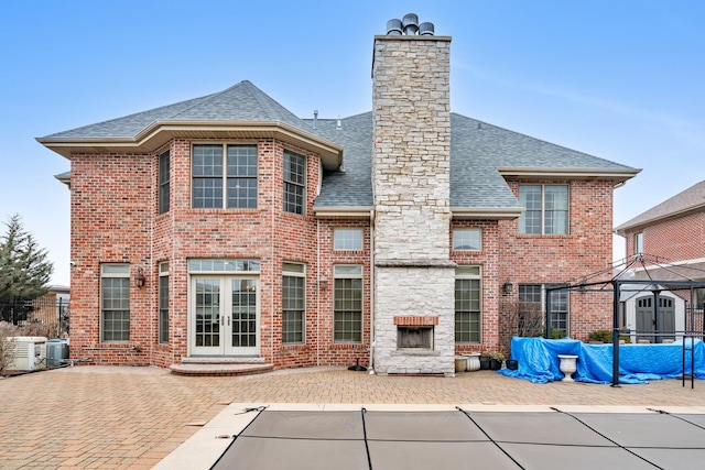 back of house with french doors, a patio area, a gazebo, central AC unit, and a fireplace