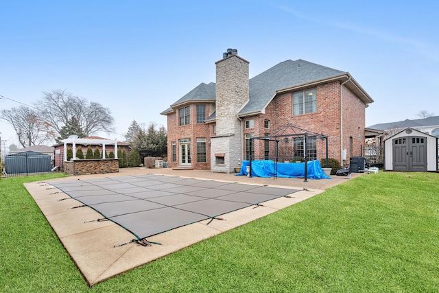 rear view of property featuring a patio, a pergola, a gazebo, a covered pool, and a storage shed