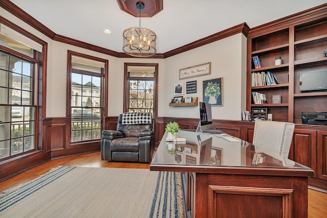 office area featuring an inviting chandelier, crown molding, and light wood-type flooring