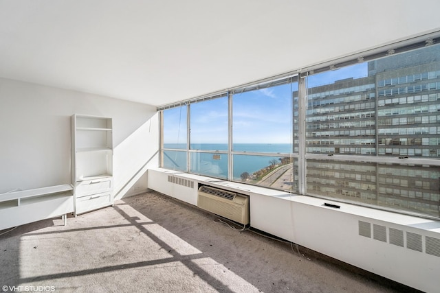 interior space with a wall unit AC and a water view