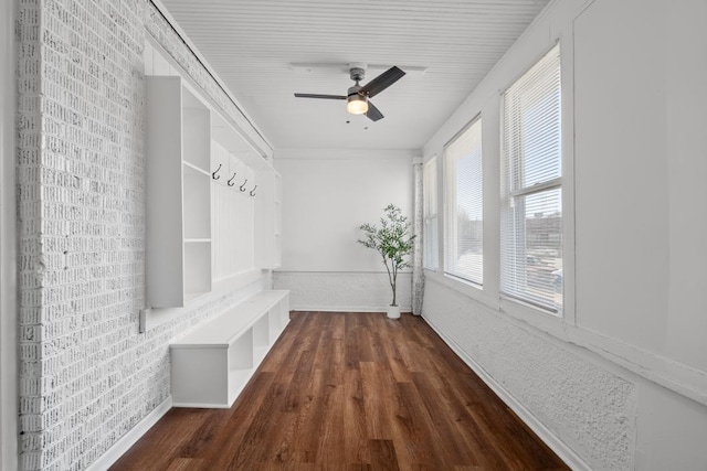 mudroom with ceiling fan, brick wall, and dark hardwood / wood-style flooring