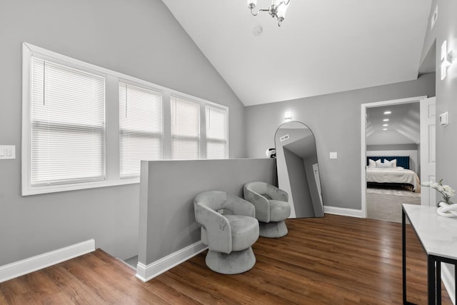 living area with lofted ceiling and dark hardwood / wood-style floors