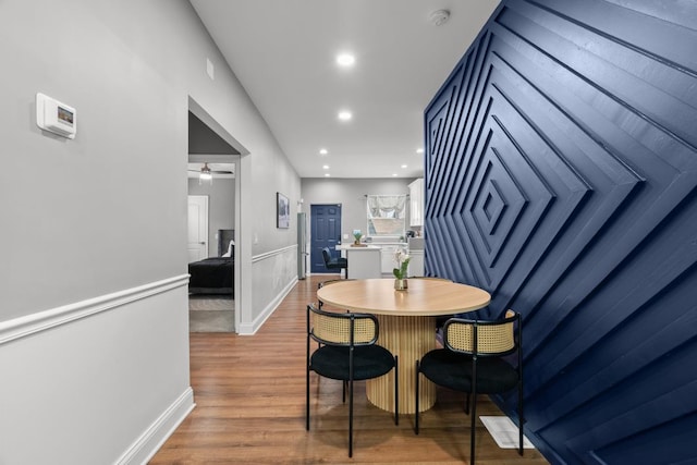 dining space featuring ceiling fan and dark hardwood / wood-style flooring