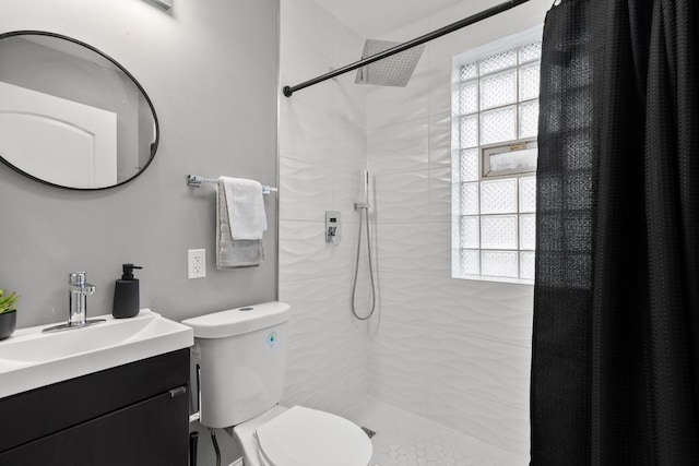 bathroom with plenty of natural light, toilet, a shower with shower curtain, and vanity