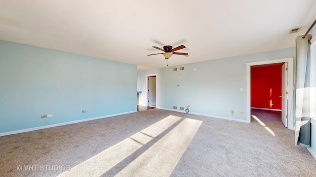 empty room with baseboards, visible vents, and carpet flooring