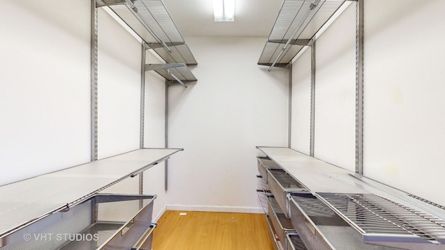 walk in closet with light wood-type flooring