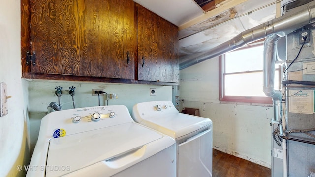 laundry room featuring cabinet space, washing machine and dryer, and dark wood finished floors