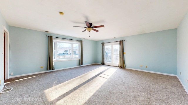 spare room featuring ceiling fan, visible vents, baseboards, and carpet flooring