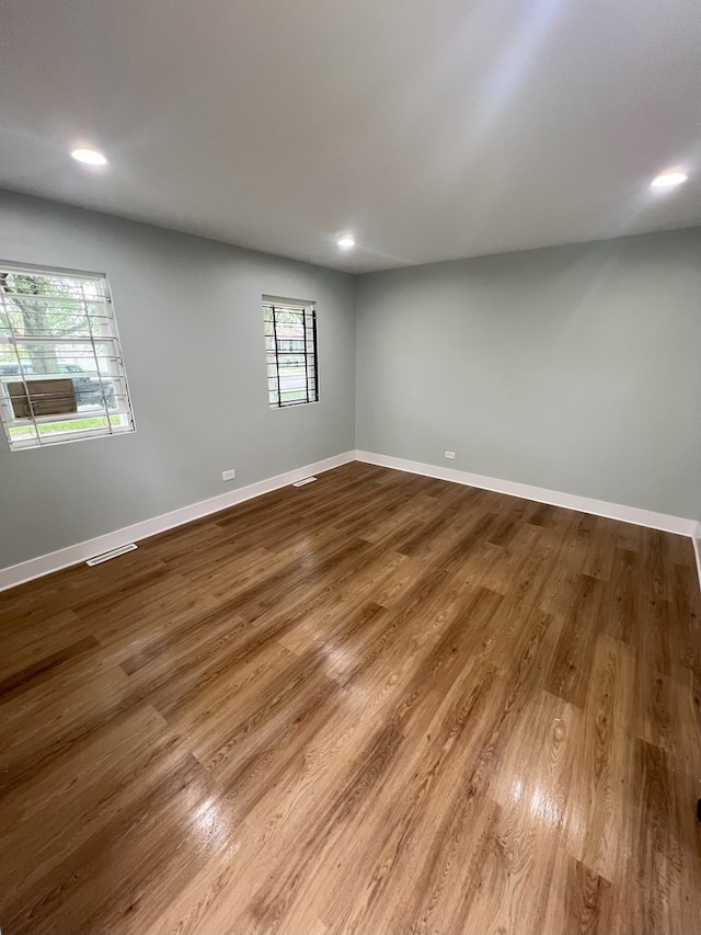 unfurnished room with wood-type flooring