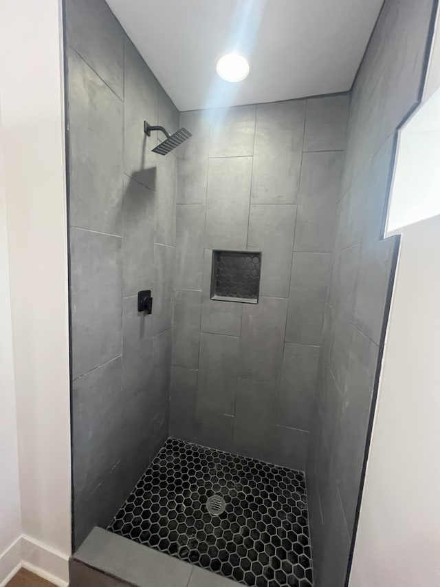 bathroom with a tile shower