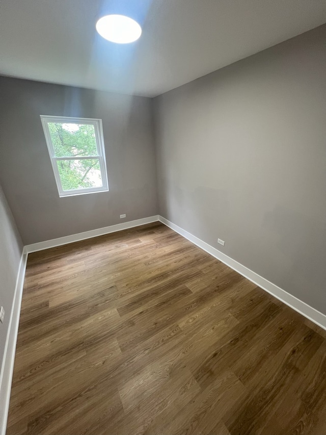 spare room with hardwood / wood-style floors