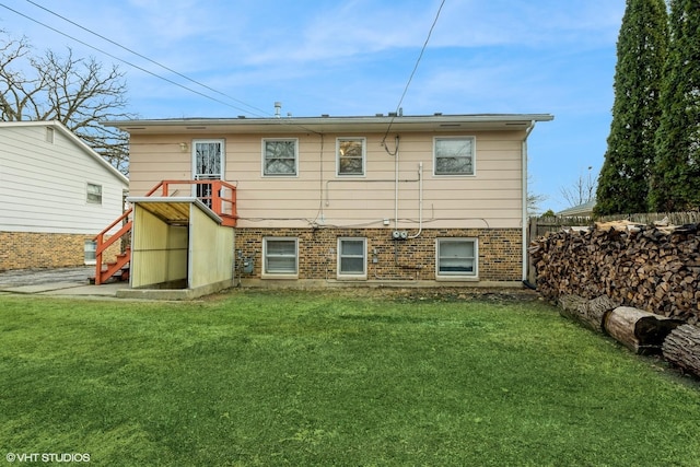 rear view of house featuring a yard