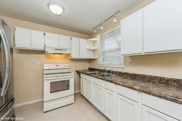 kitchen featuring sink, light tile patterned floors, stainless steel fridge, white range with electric stovetop, and white cabinets