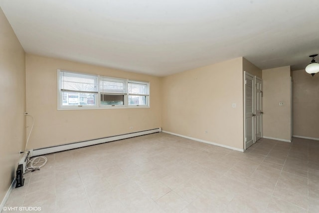 unfurnished room featuring a baseboard heating unit