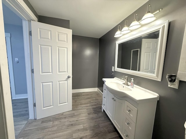 bathroom featuring hardwood / wood-style flooring and vanity