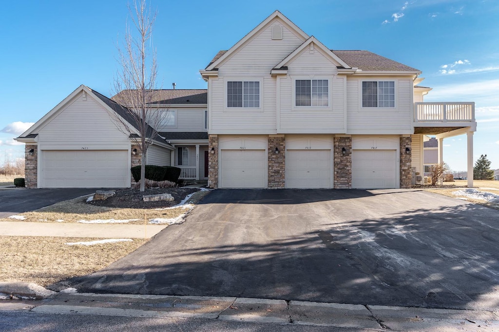 view of front of home with a balcony and a garage