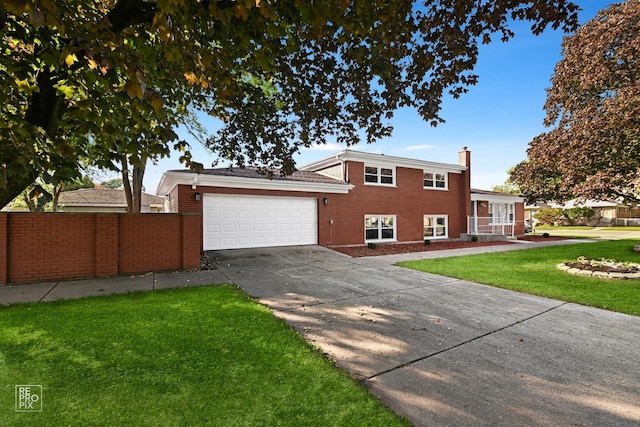 view of front of home with a garage and a front yard