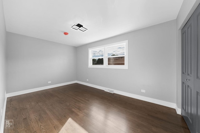 empty room featuring dark hardwood / wood-style floors