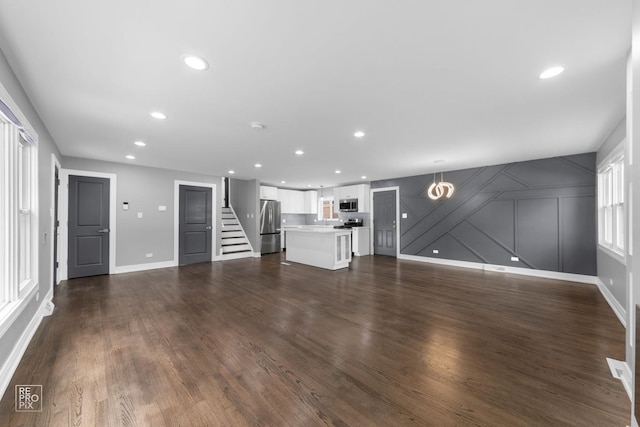 unfurnished living room featuring dark wood-type flooring