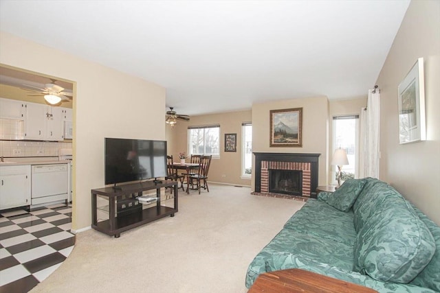 living room with sink, a fireplace, and ceiling fan