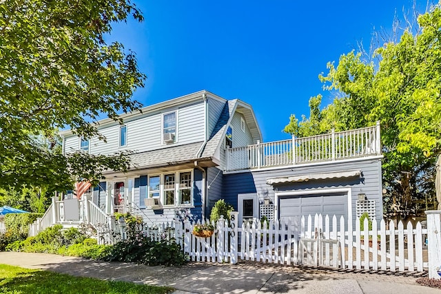 front facade featuring a balcony and a garage