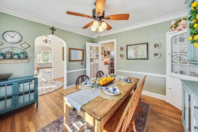 dining space featuring crown molding, ceiling fan, and hardwood / wood-style floors