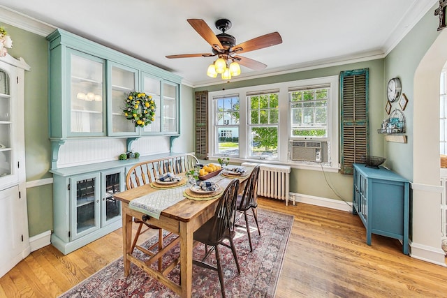 sunroom / solarium with cooling unit, radiator heating unit, and ceiling fan