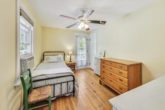 bedroom with ceiling fan, access to outside, light wood-type flooring, and cooling unit