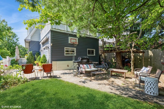 back of house with a yard and a patio area