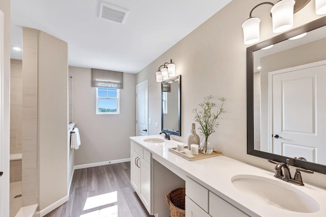 bathroom with vanity, wood-type flooring, and walk in shower