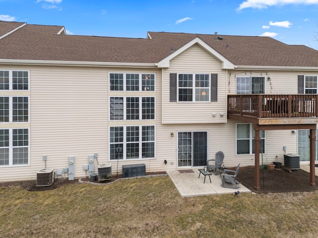 rear view of property featuring cooling unit, a patio, and a lawn