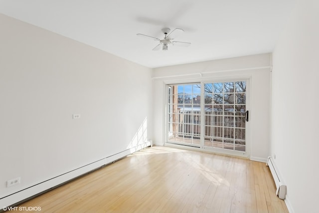 empty room with a baseboard heating unit, baseboards, light wood-style floors, and a ceiling fan