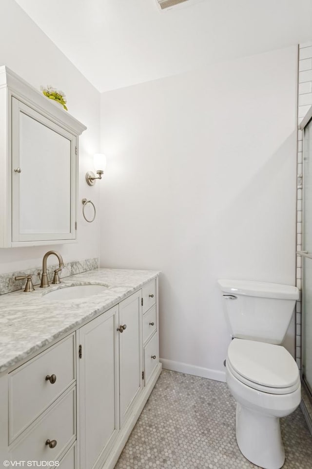 bathroom with visible vents, baseboards, toilet, and vanity