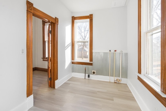 clothes washing area with hookup for an electric dryer and light hardwood / wood-style floors