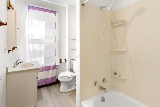 full bathroom featuring vanity, shower / tub combination, toilet, and wood-type flooring