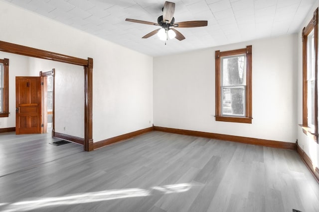 empty room with ceiling fan and light wood-type flooring