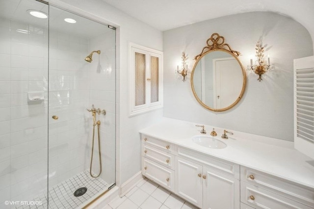 bathroom featuring tiled shower, vanity, and tile patterned floors