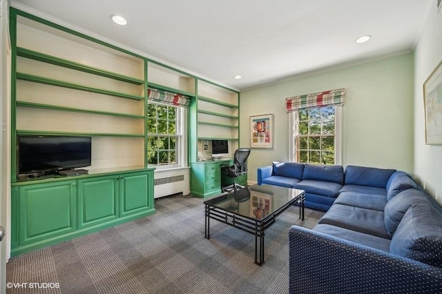 carpeted living room with radiator and ornamental molding