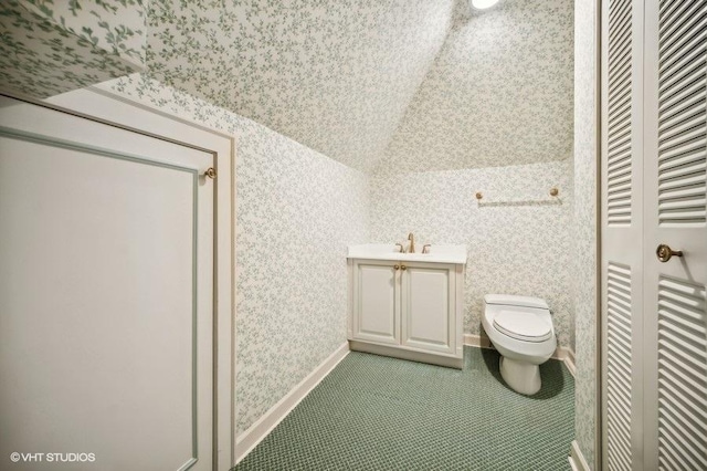 bathroom with tile patterned flooring, vanity, and toilet