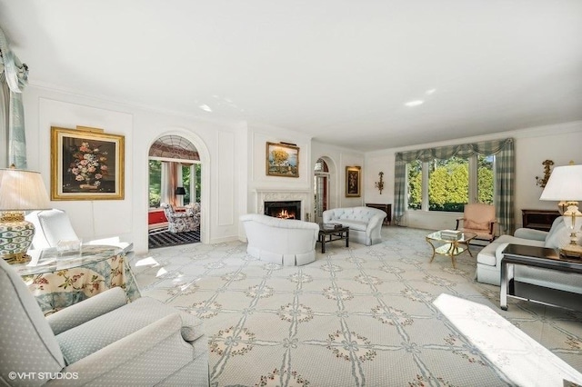 living room featuring ornamental molding and plenty of natural light