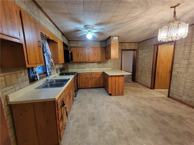 kitchen featuring sink, hanging light fixtures, ceiling fan, kitchen peninsula, and gas stove