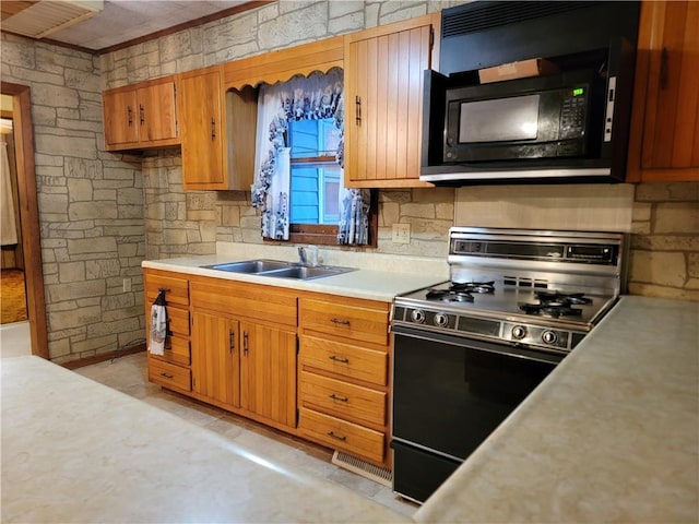 kitchen featuring sink, decorative backsplash, and black appliances